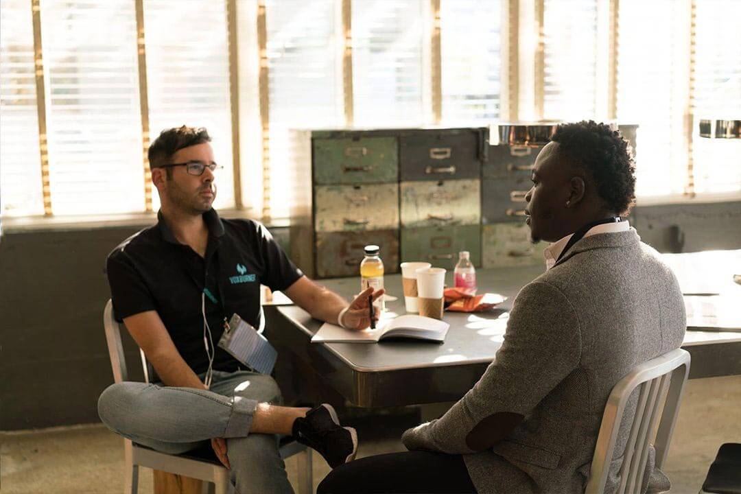 Two people talking in an office.