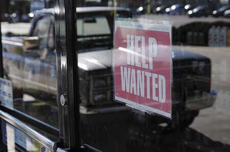 Wanted sign in window of a business.