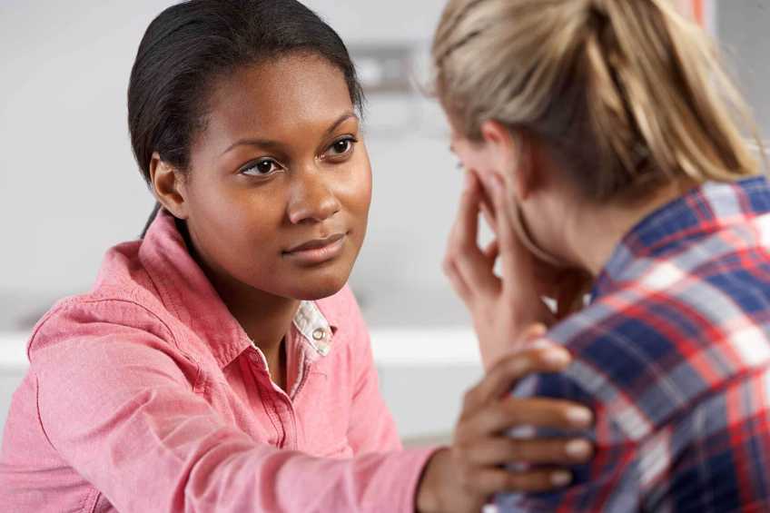 Counsellor comforting a woman in distress.