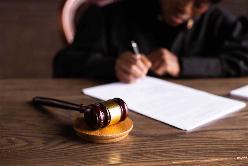 Judge signing bail release papers
