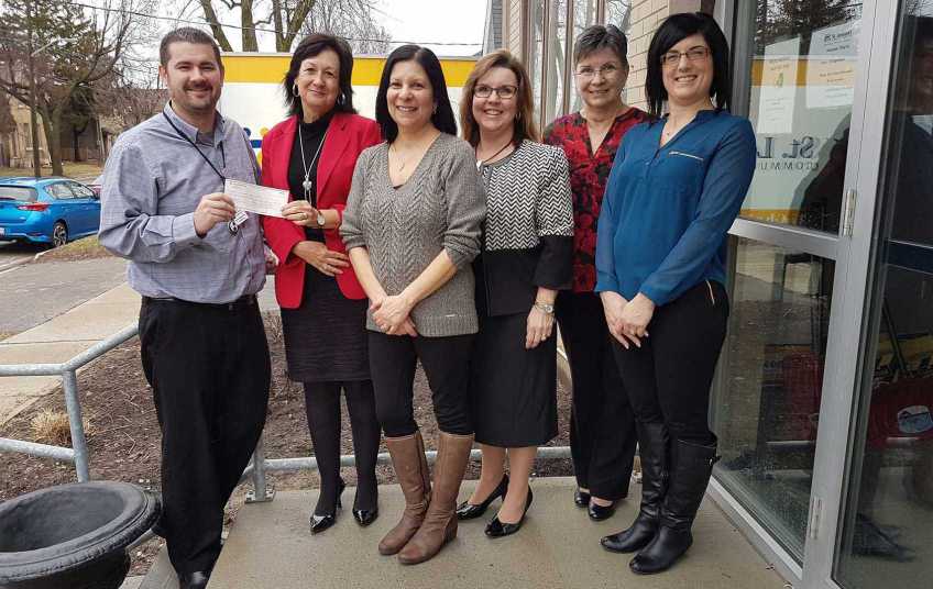 Scotiabank volunteers standing in front of a building on the sidewalk.