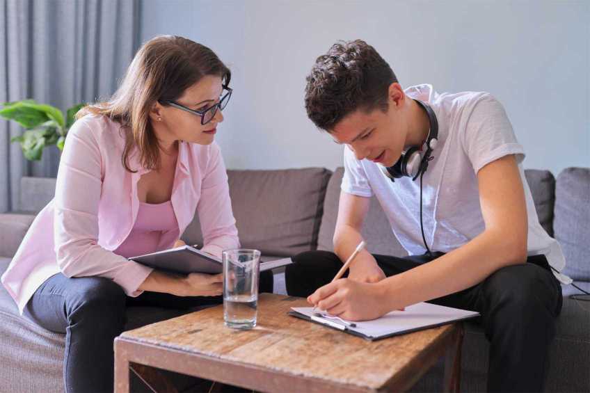 A teenage boy receiving support from a therapist