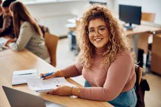 girl at desk smiling 